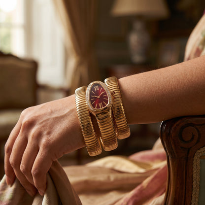 Red snake watch bracelet coiled on wrist