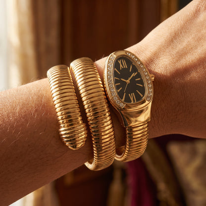 Black snake watch bracelet coiled on wrist