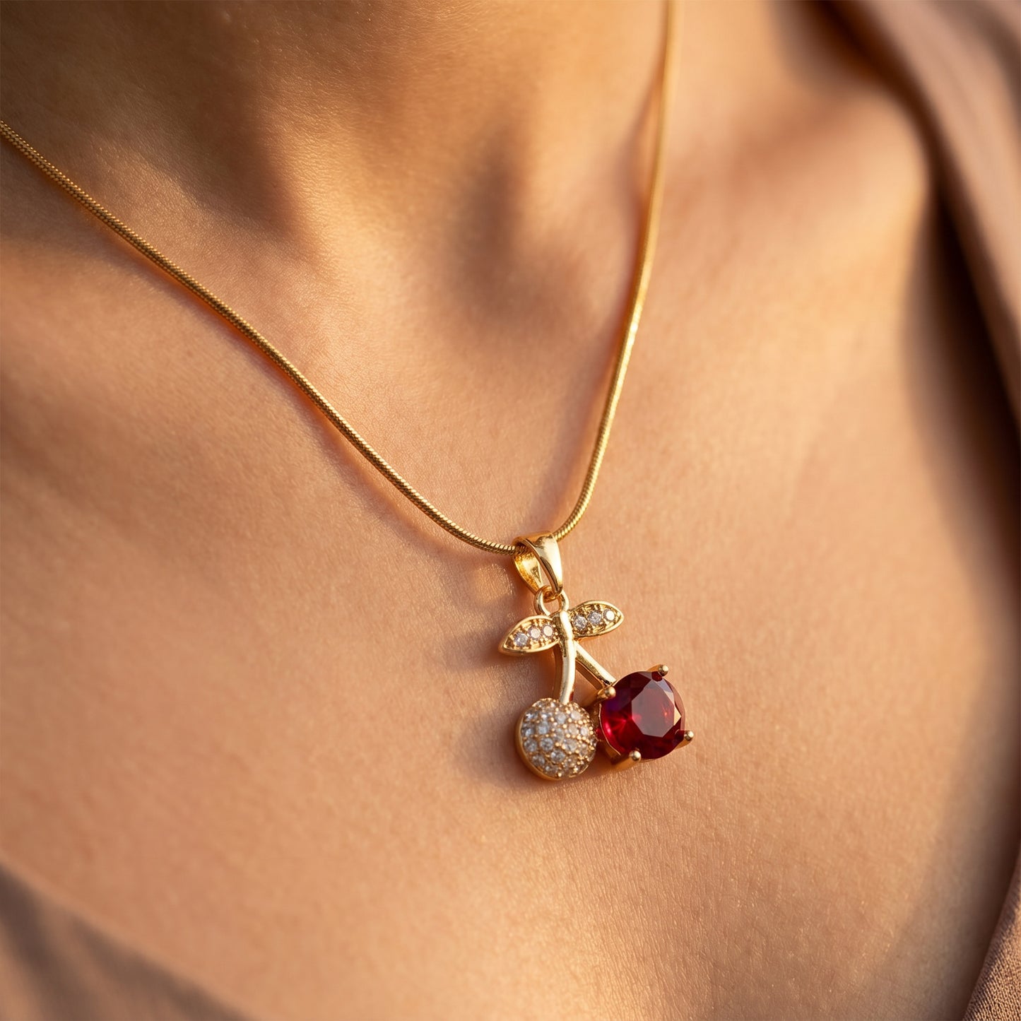 Cherry pendant resting on collarbone