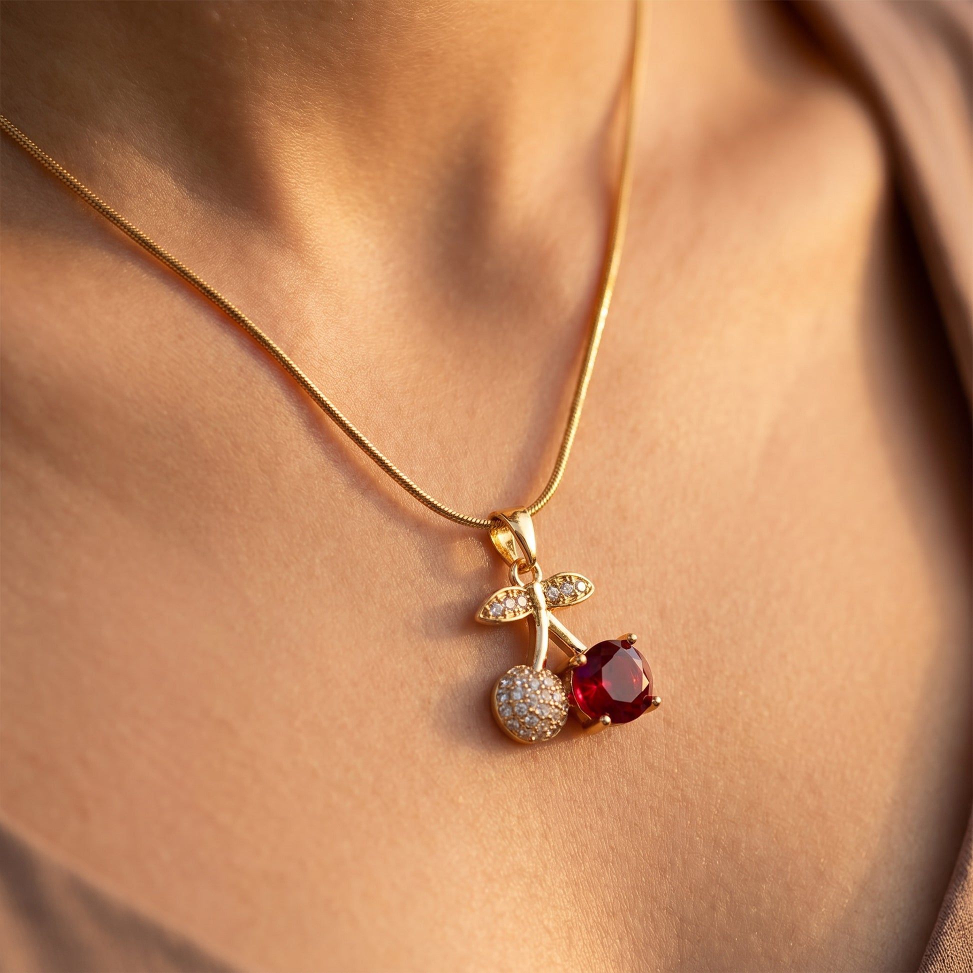 Cherry pendant resting on collarbone